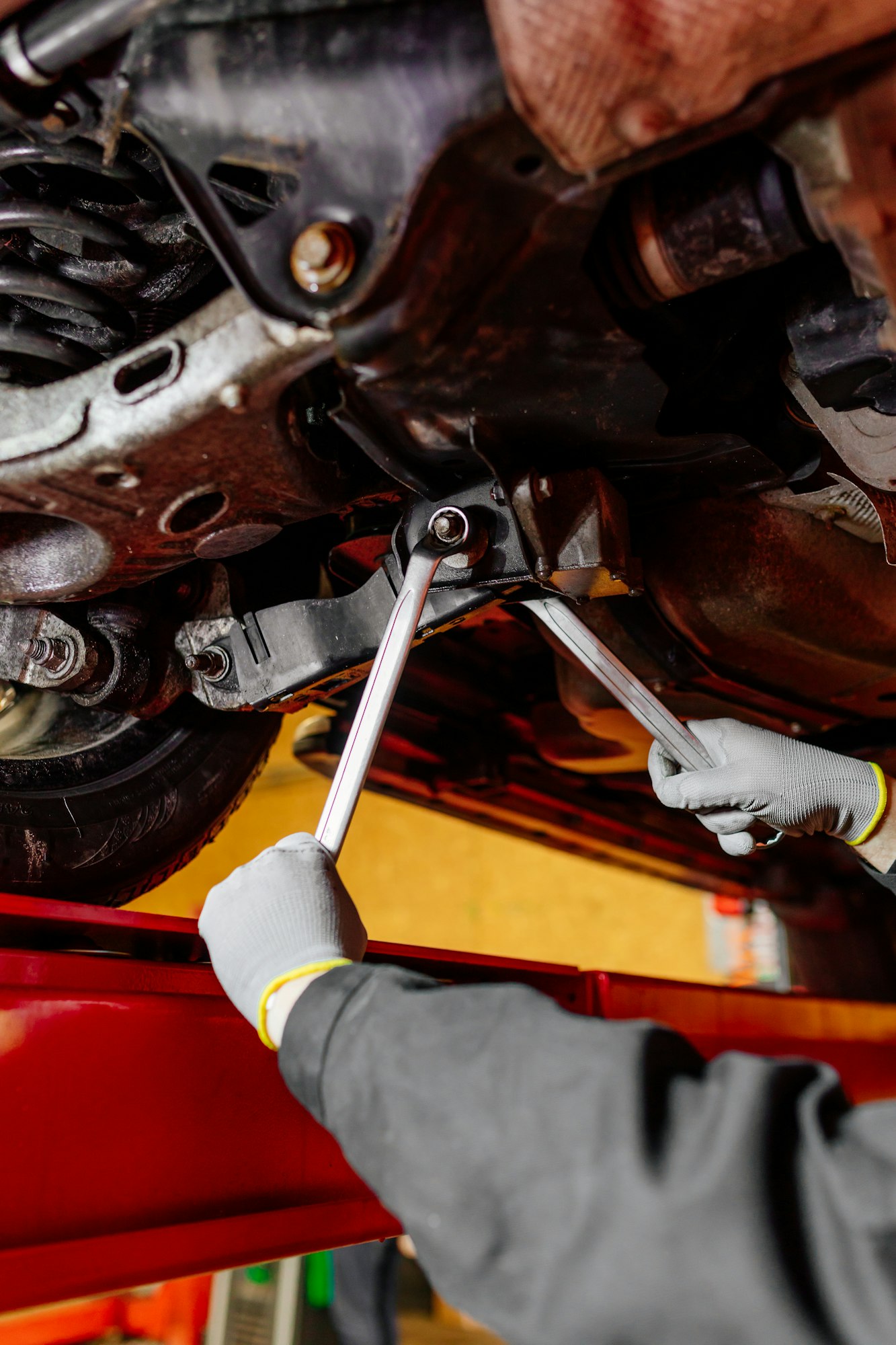 Car mechanic installing wheel alignment sensors